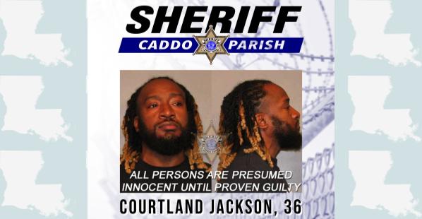 Courtland Jackson, 36, Keithville, Louisiana A black male from Keithville, Louisiana. He has a short, curly dark beard. His hair is dark and braided with some of the ends of his hair being blonde. He is wearing a black shirt.