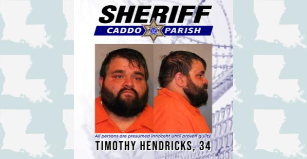 A white male from Keithville, Louisiana. He has short dark hair and a dark mid-length beard. He is wearing an orange correctional center shirt.