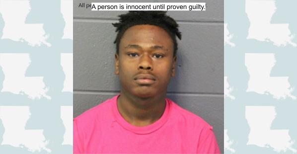 A black 19-year-old male from Ponchatoula, Louisiana. He has medium length, dark hair on the top of his head with the sides cut very short. He is wearing a pink t-shirt.