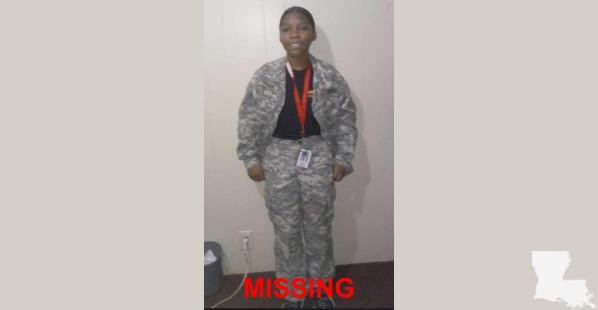 A black female from Louisiana. She is wearing camouflaged pants and jacket with a black undershirt.